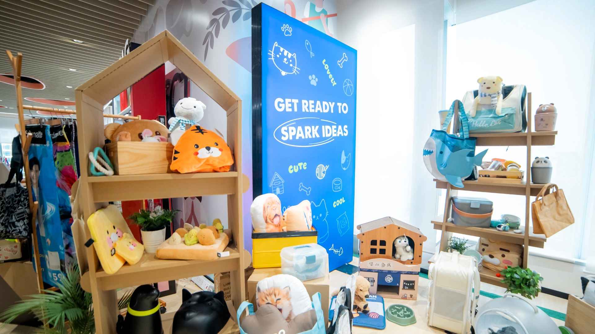 A colourful display of toys and items in a retail setting with a sign that says "Get ready to spark ideas".